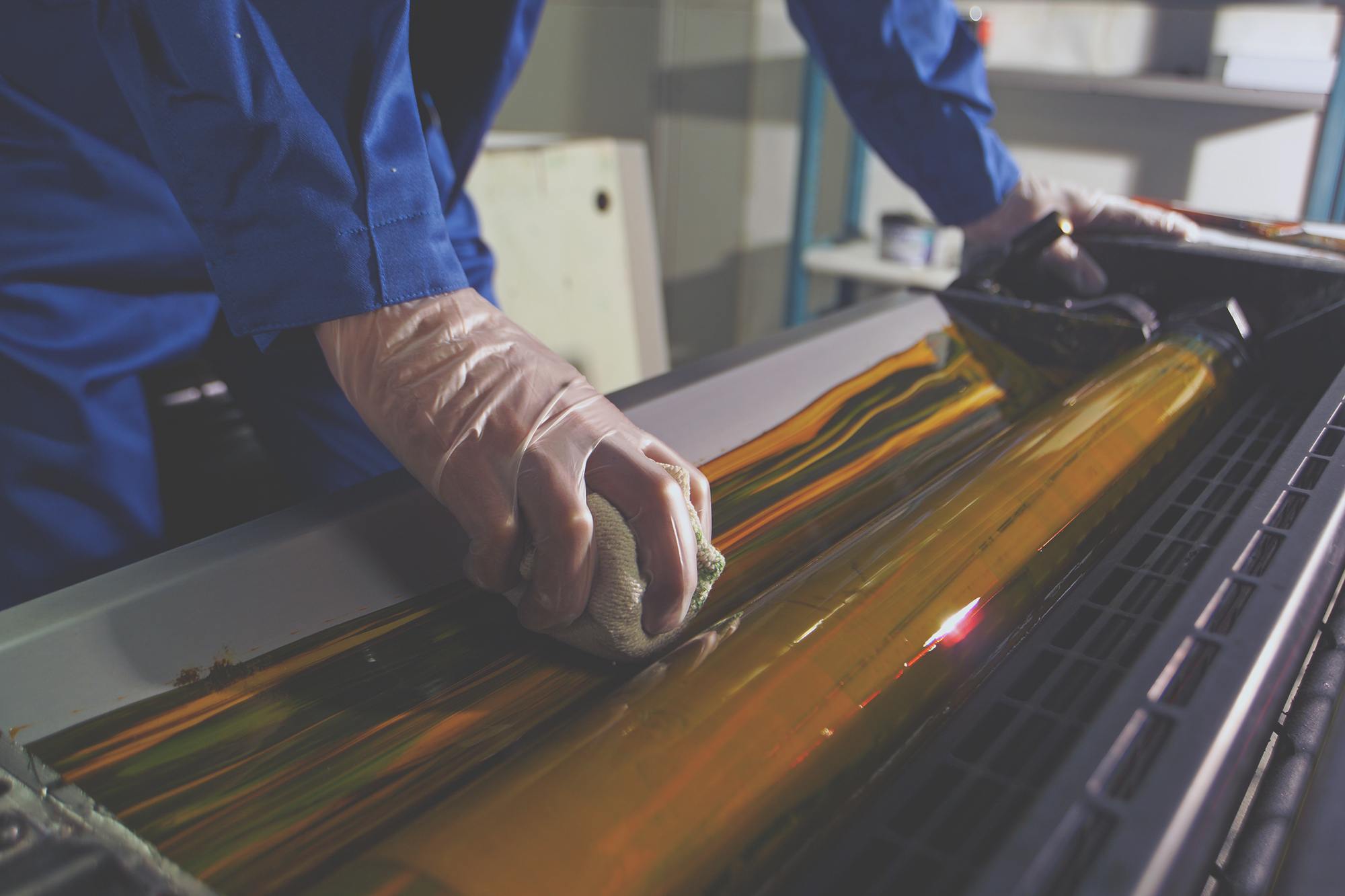 Man using print industry wipes to clean his machines