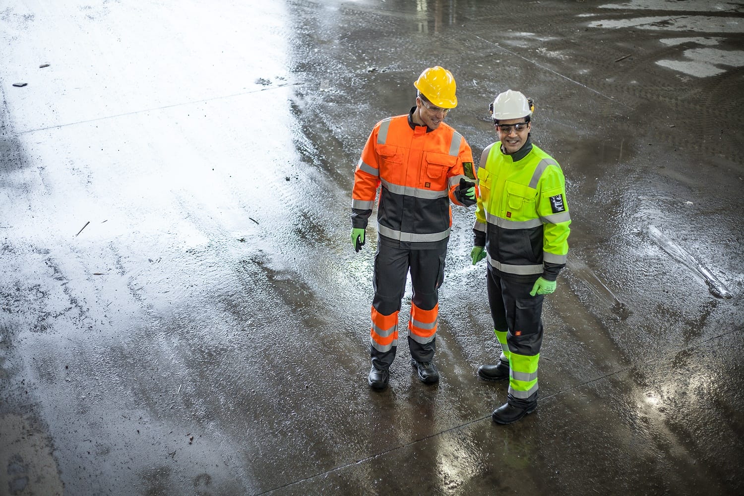 two men wearing high visibility construction clothing
