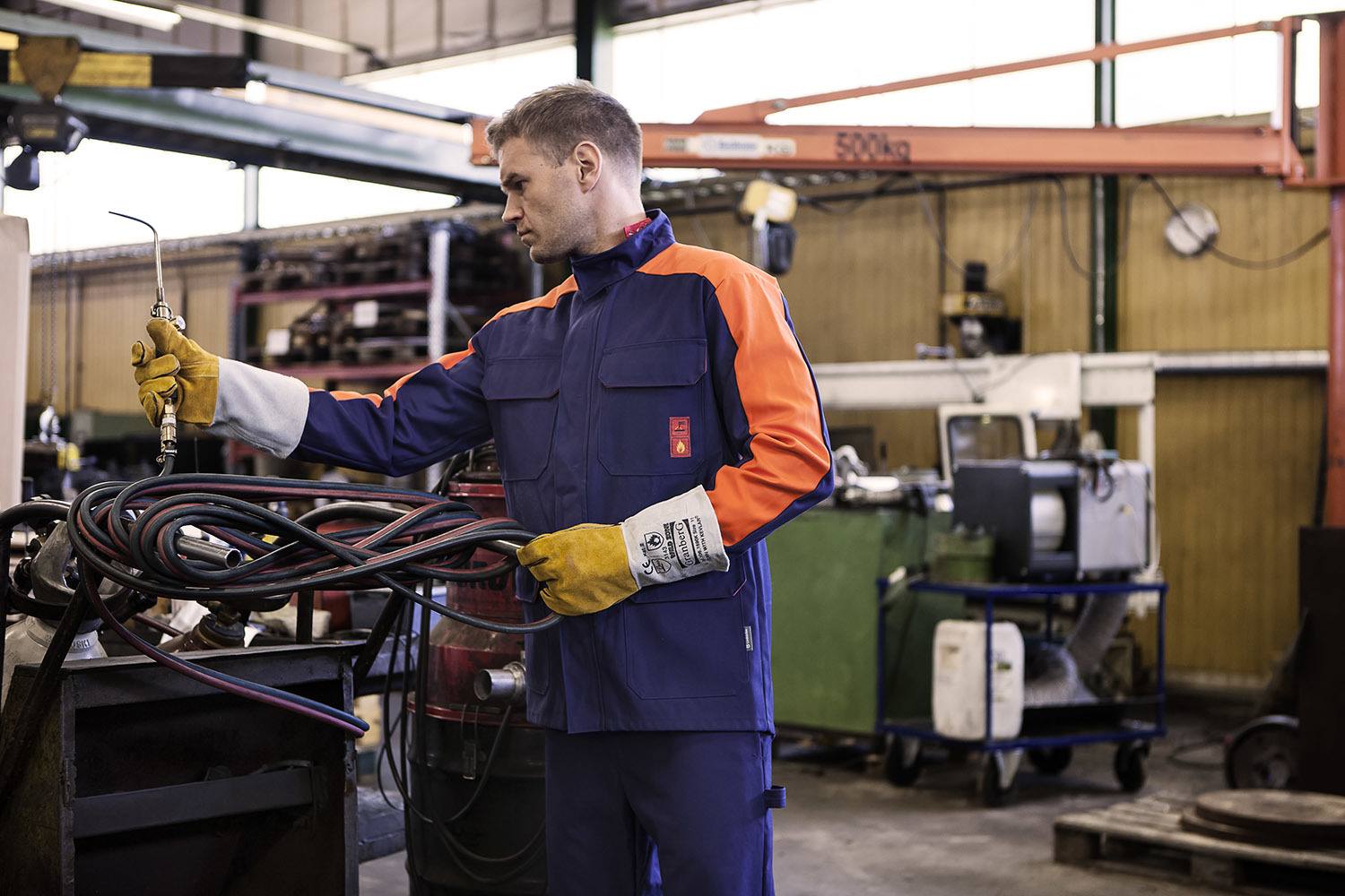 employee wearing flame retardant mechanic overalls for welding