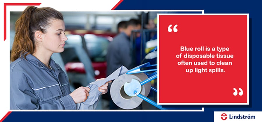 mechanic tearing off some disposable blue roll tissue to clean with