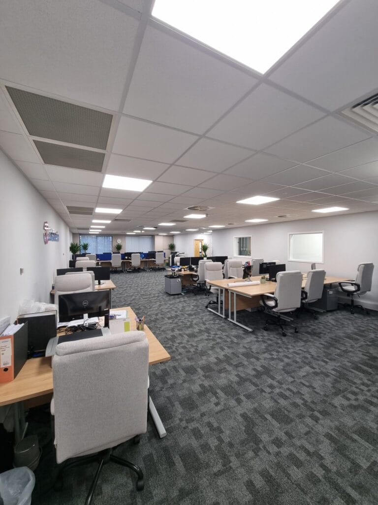 Spacious office area with multiple desks and chairs at Lindström’s Bedford office.