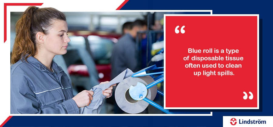 Mechanic tearing off a piece of blue roll to clean with.