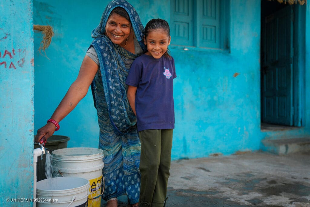 In the village of Kotdi, Shanti Bai and her seven-year-old daughter Garima fill water from the tap now installed at their home — a transformation made possible through the rural water supply scheme initiated under the Jal Jeevan Mission.