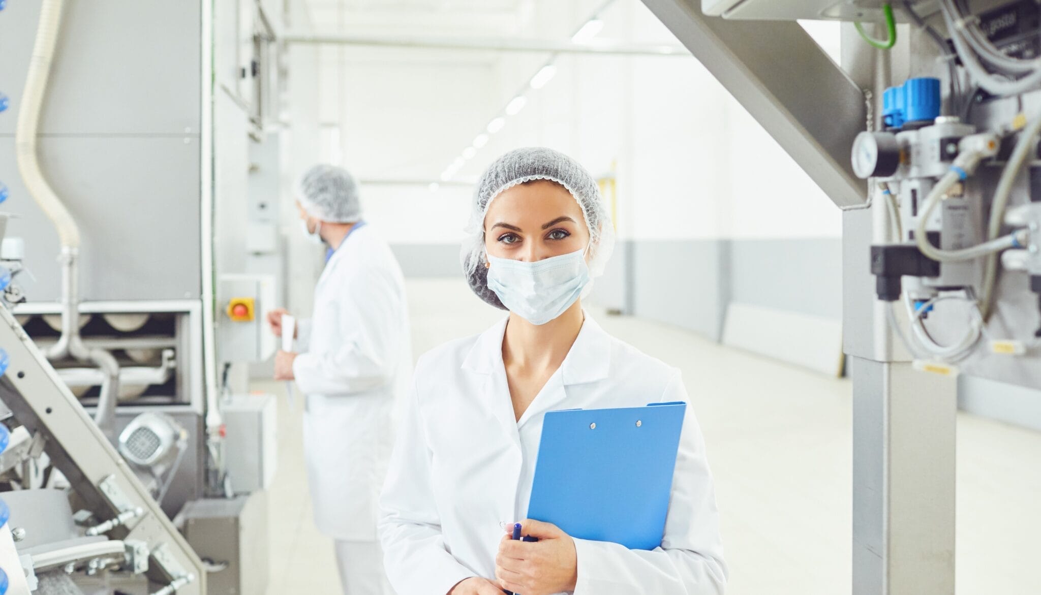 A woman in mask at food factory.
